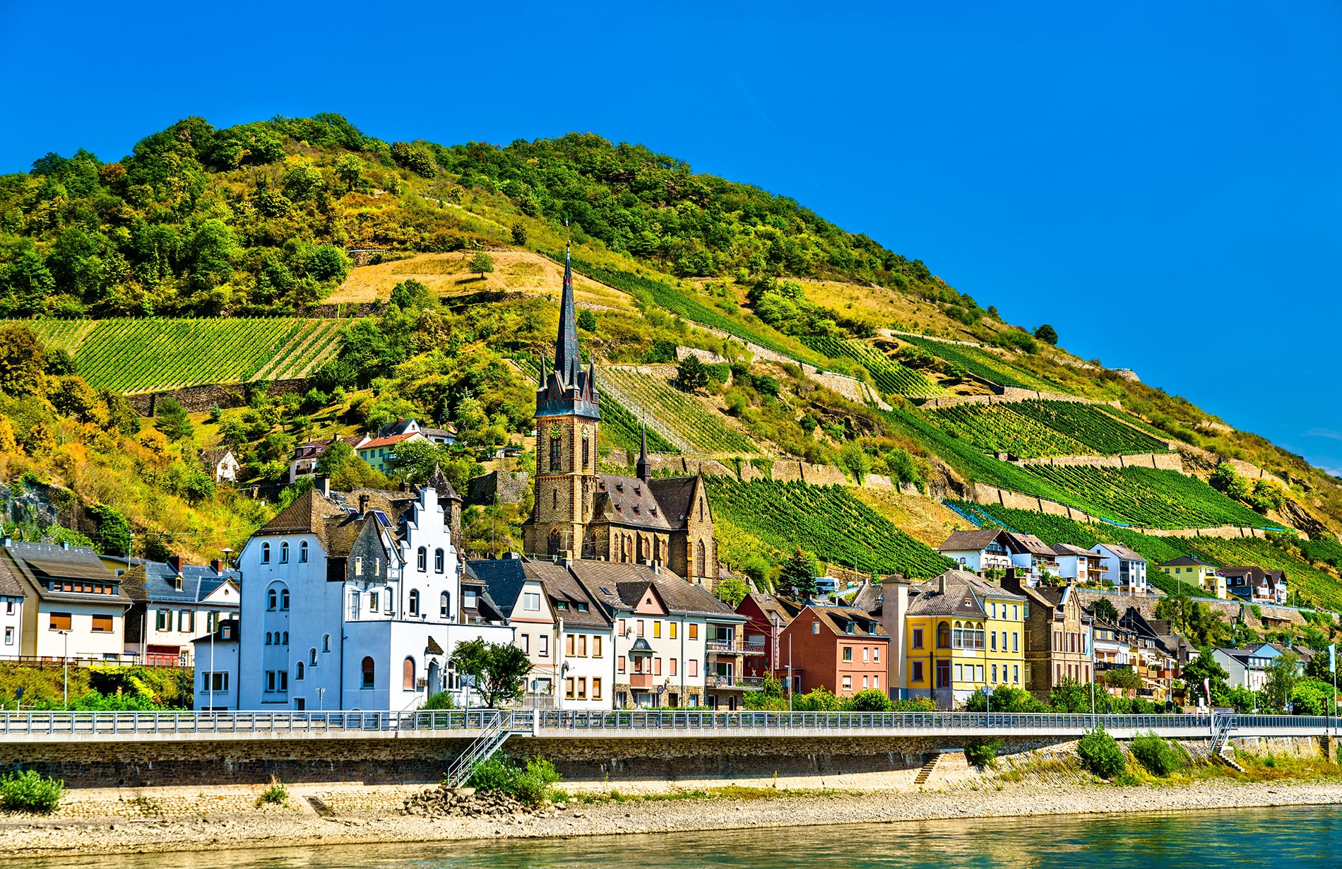 Nestled beneath steep, vine-ripened hillsides in the UNESCO-listed Rhine Gorge, the picturesque village of Lorchhausen and its striking Saint Boniface Church showcase the timeless beauty of Germany’s historic riverfront