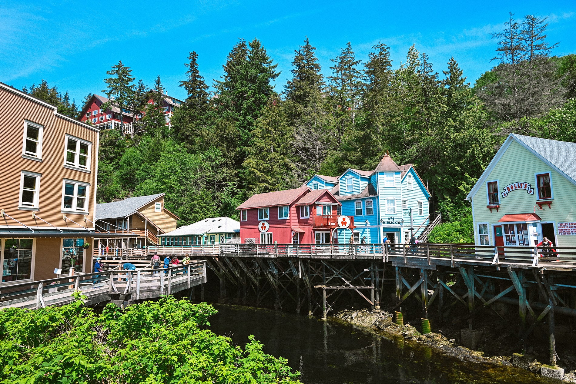 Perched over the water on wooden pilings, historic Creek Street blends Ketchikan’s colorful rold rush past with vibrant pastel shopfronts along Alaska’s Inside Passage