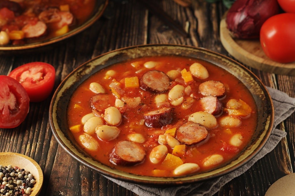 A bowl of homestyle ciorbă de fasole, a savory bean soup presented in a classic, rustic fashion.