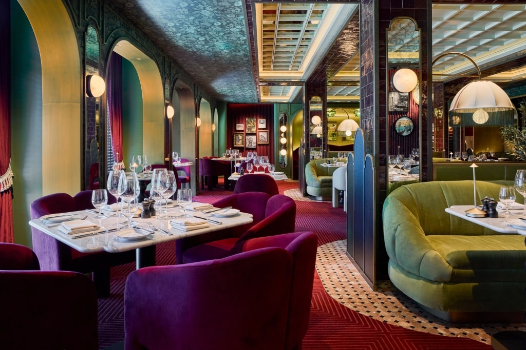 The elegant, Italian-inspired dining room interior of Trattoria Rossa, a specialty restaurant aboard Celebrity Cruises.