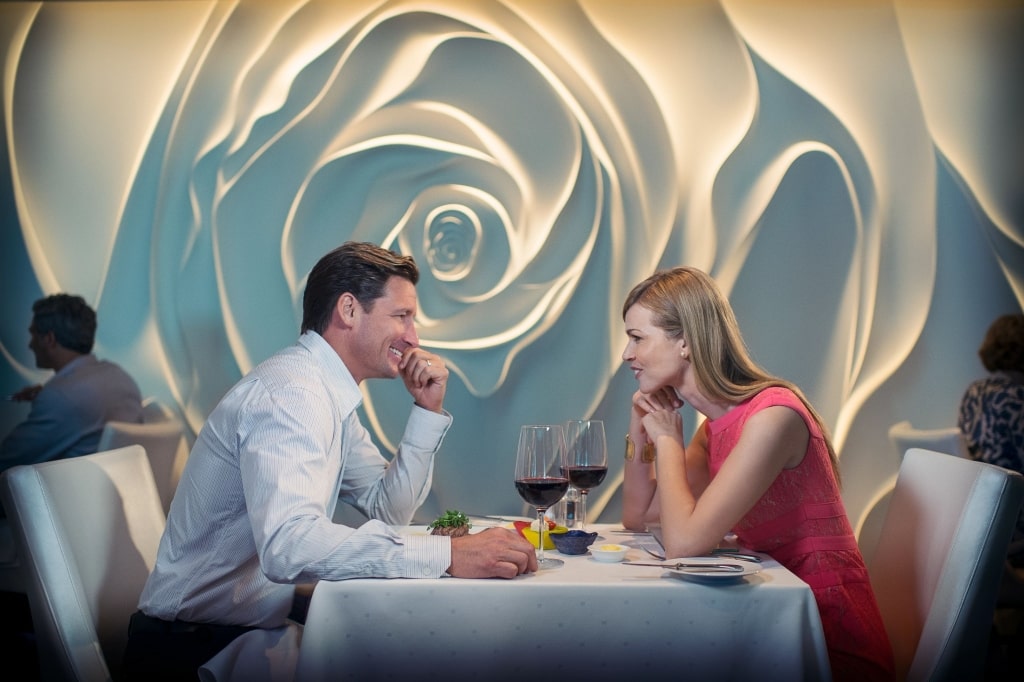 A couple enjoys an intimate fine dining experience inside Blu, the exclusive AquaClass restaurant featured aboard Celebrity Cruises Solstice Series ships.