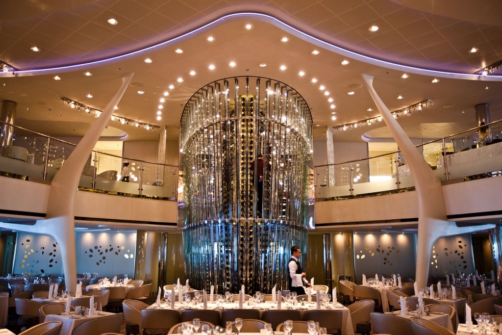The two-story main dining room, Grand Epernay, features its signature glass wine tower aboard Celebrity Solstice.