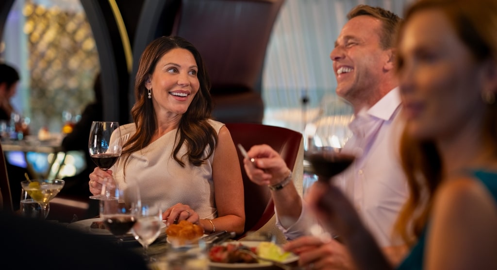 Guests enjoy fine wine and lively conversation in the elegant setting of Fine Cut Steakhouse.