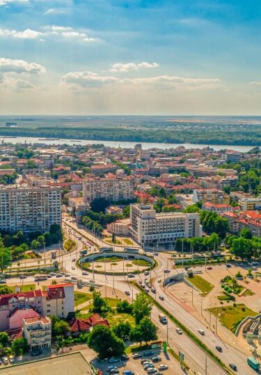 Wide aerial drone shot of roundabout and Danube river in city of Ruse, Bulgaria