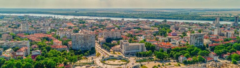 Wide aerial drone shot of roundabout and Danube river in city of Ruse, Bulgaria