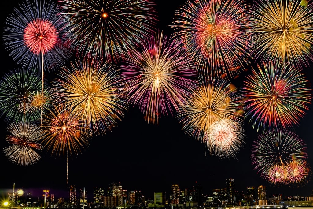 Unique and colorful fireworks over Osaka city in the Naniwa Yodogawa Fireworks Festival.