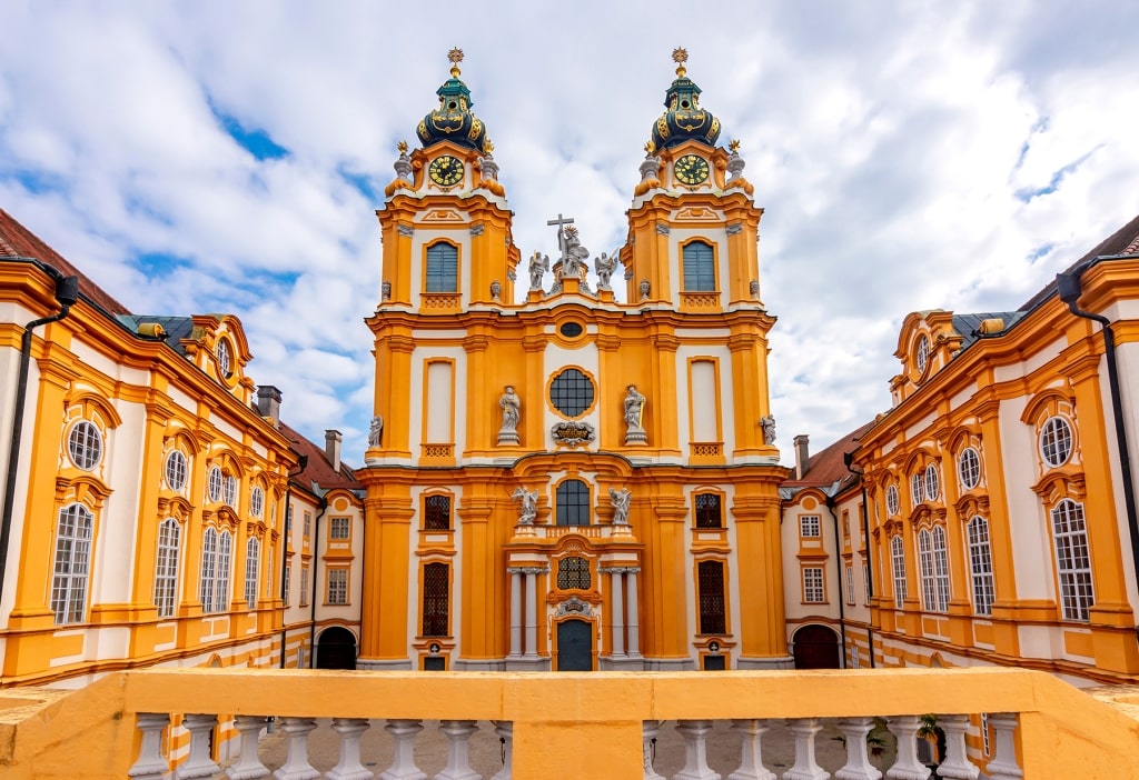 A pair of soaring towers flanks the brilliant ochre-yellow Baroque exterior of the Abbey Church.