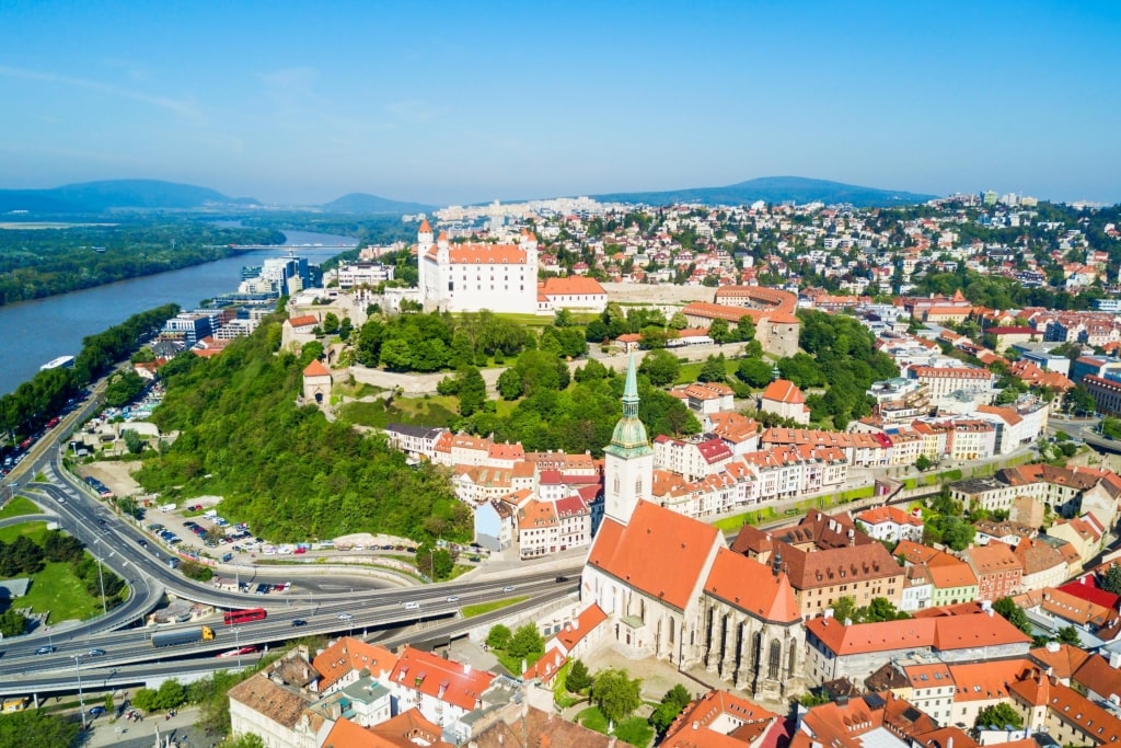 Perched grandly on the hill above, Bratislava Castle overlooks the historic cathedral and colorful roofs below.
