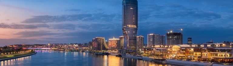 Panoramic night view of Belgrade Waterfront and the Sava River, with Belgrade Tower.