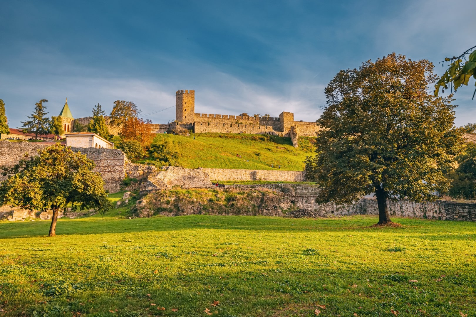 The Despot Stefan Tower and stone ramparts of the Upper Town in the Belgrade Fortress (Kalemegdan), overlooking green lawns.