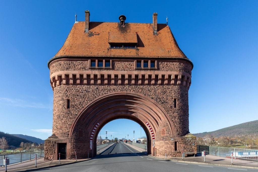 The historic sandstone bridge gate tower (Miltenberger Brückentor) frames the entrance to the bridge over the Main River.