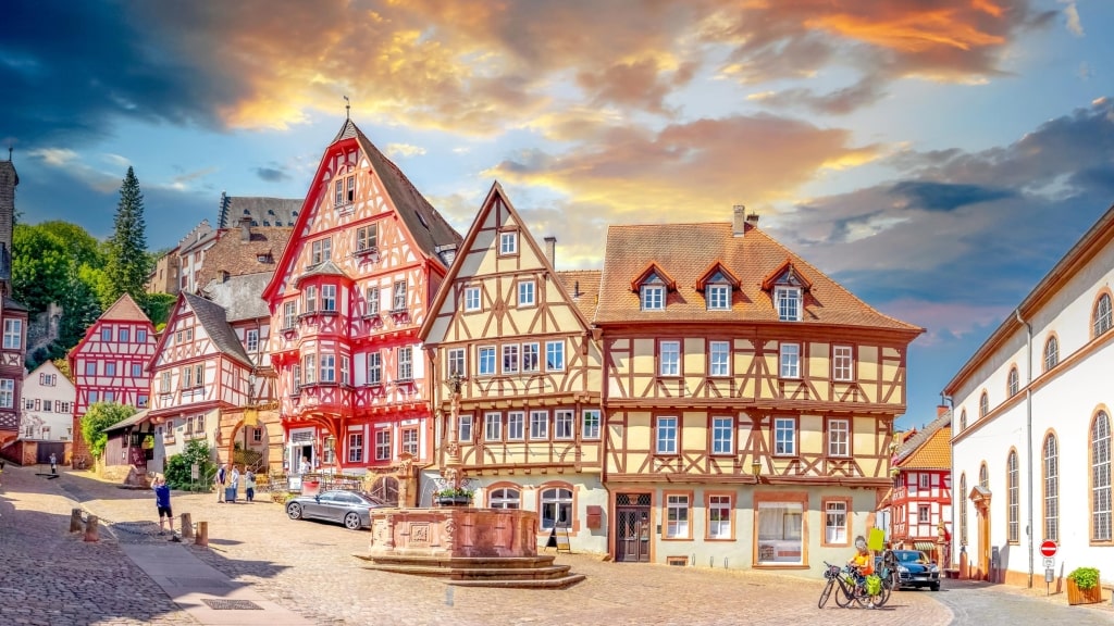 Historic half-timbered buildings and the Market Fountain in the historic marketplace (Marktplatz) during golden hour.
