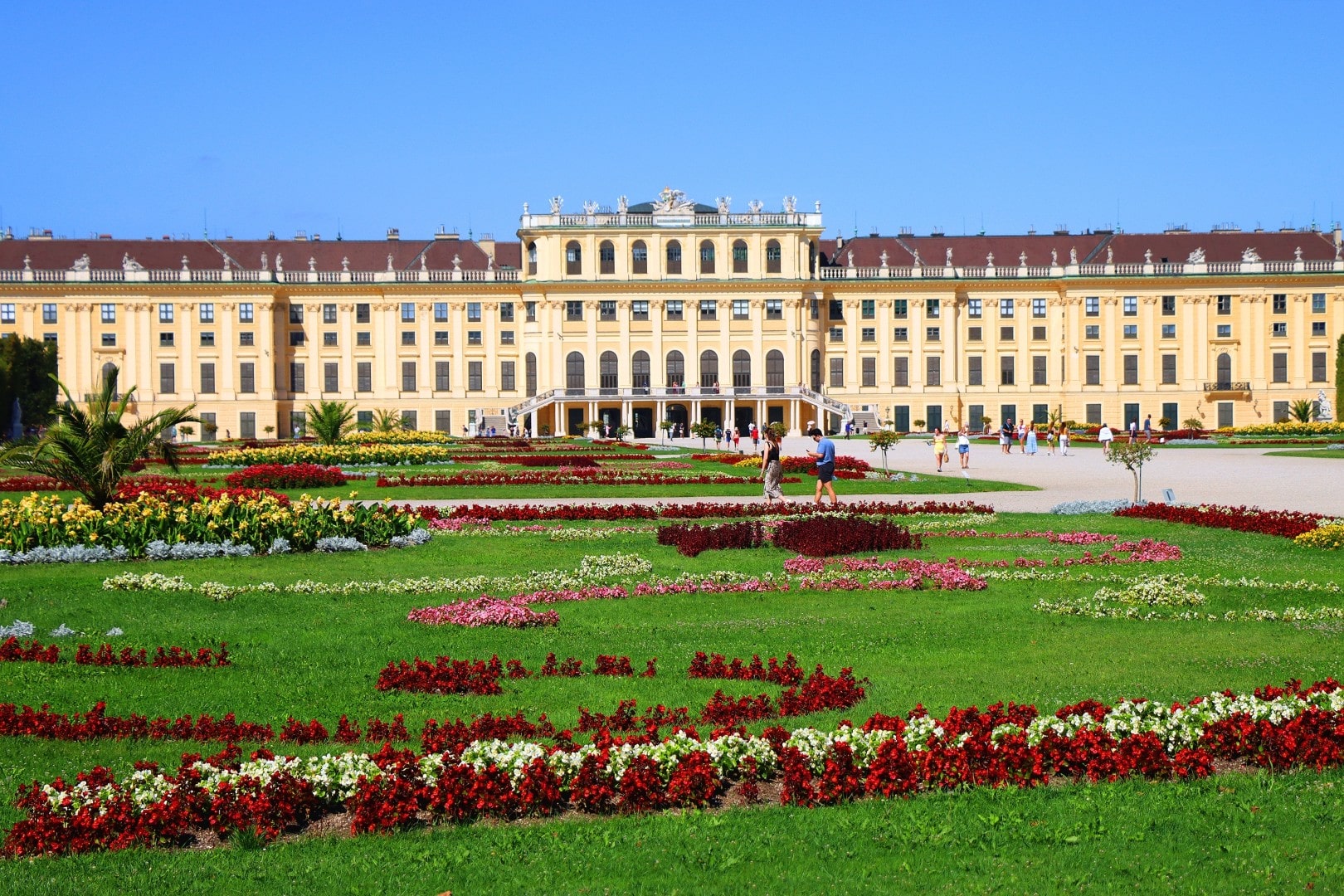 Famous Vienna landmark, Schönbrunn Palace (Schloss Schönbrunn), framed by colorful flowerbeds in the Great Parterre gardens