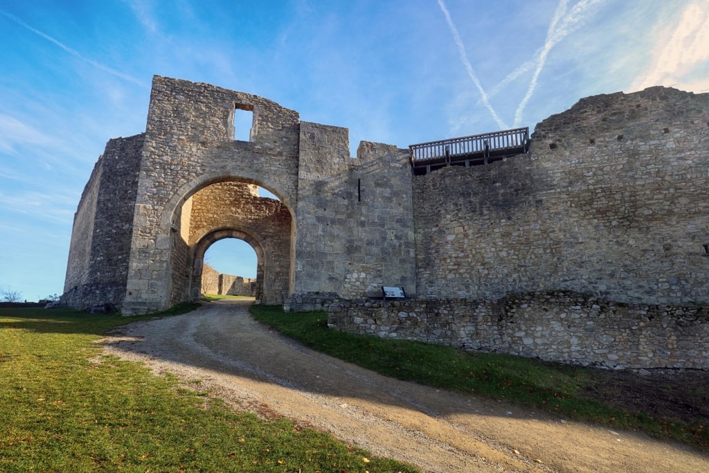 Centuries-old stone arches frame an inviting walkway amidst the ruins of Hainburg Castle.
