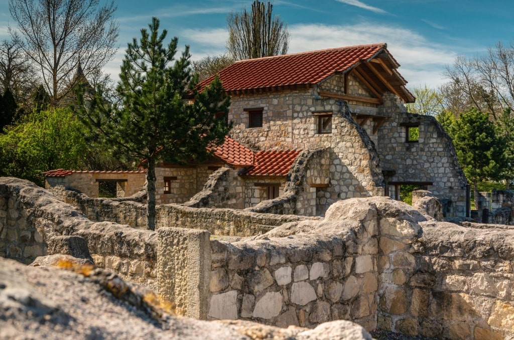 Centuries-old stone walls frame the reconstructed exterior of Roman public baths at Carnuntum.