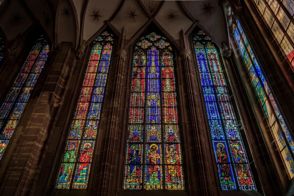 Ornate colorful stained glass windows in the beautiful Gothic cathedral of Notre Dame in the historic center of Strasbourg.