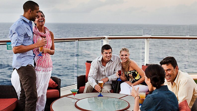 https://www.celebritycruises.com/is/image/content/dam/celebrity/eat-and-drink/6949-group-sitting-standing-ed-sunset-bar.jpg?$16x9-med$