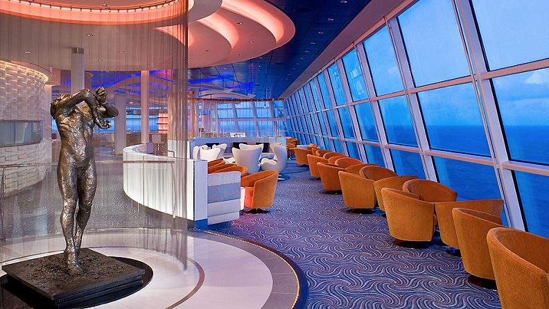 https://www.celebritycruises.com/is/image/content/dam/celebrity/eat-and-drink/7038-orange-chairs-eat-and-drink-sky-observation-lounge.jpg?$16x9-med$