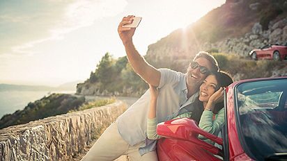 Couple taking a selfie on a ferrari